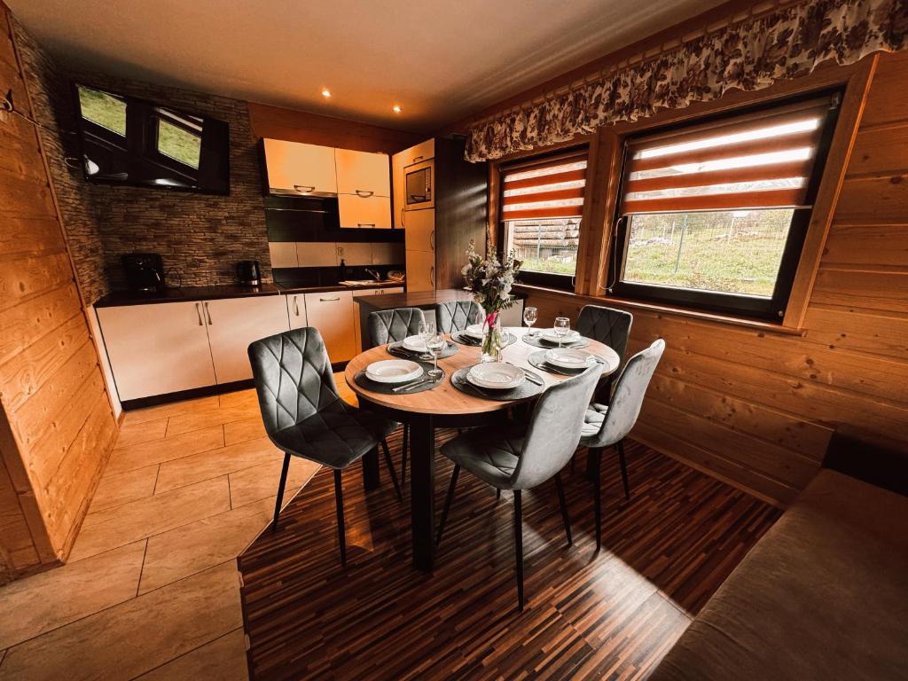 a dining room table and chairs in a kitchen at Domek Przy Potoku in Murzasichle