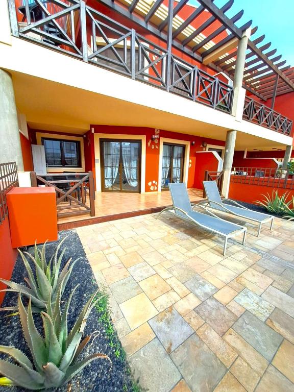 a patio of a house with two lounge chairs at Buen Camino El Cotillo in El Cotillo