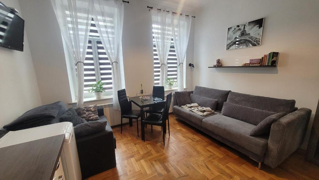 een woonkamer met een bank en een tafel bij Studio Sanowa in Przemyśl