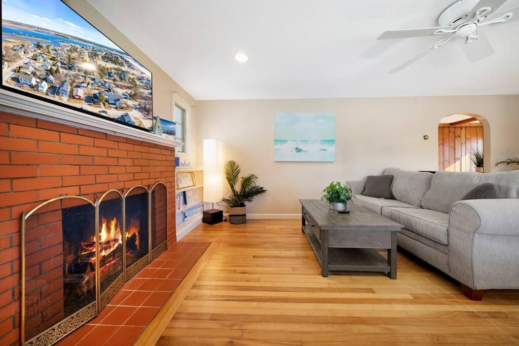 a living room with a couch and a fireplace at Seaside Serenity: Charming 2BR Escape - Parking in Scarborough