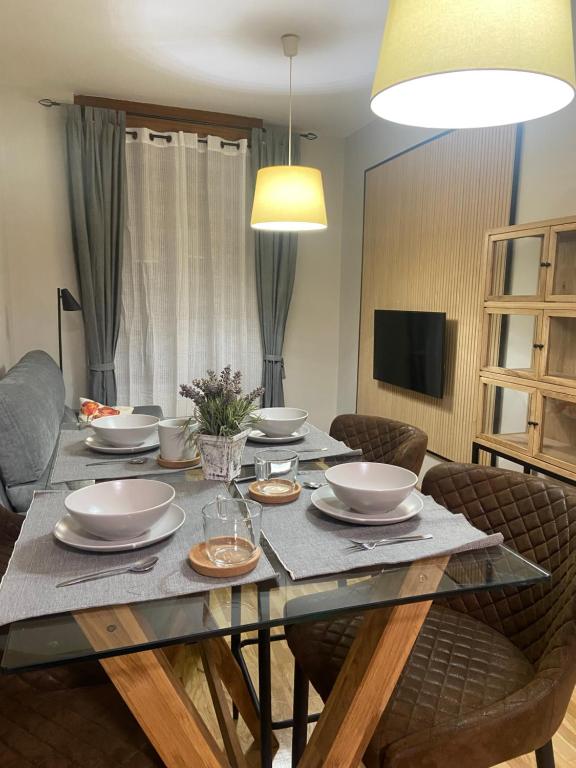 a dining room table with bowls and plates on it at Apartamento casco histórico in Zamora
