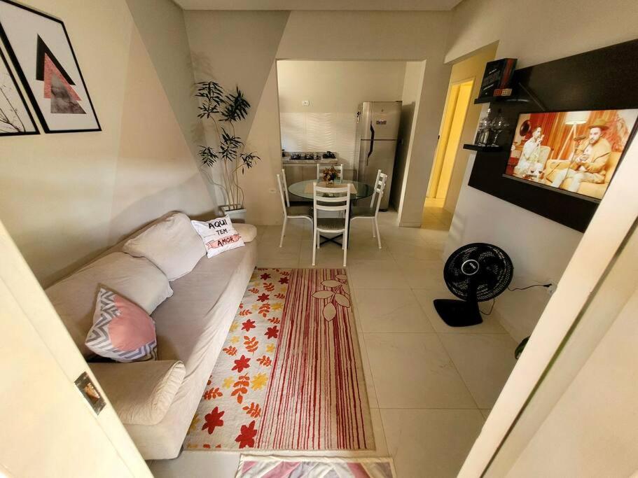 a living room with a white couch and a table at Lugarzin1 - Privado e Aconchegante in Vitória da Conquista
