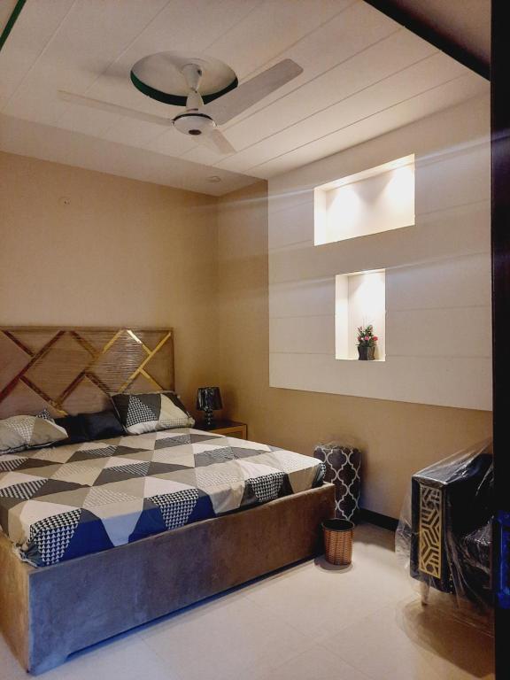 a bedroom with a bed and a ceiling at Dream home 2 & 4 bedroom Family house in Karachi