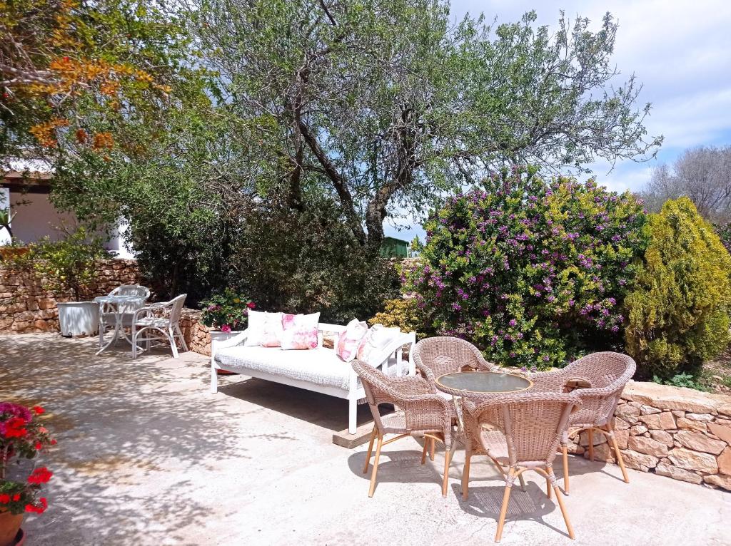 a patio with a couch and chairs and a table at Casa Rural Es Cap de Barbaria Can Joan Guillem in Sant Francesc Xavier