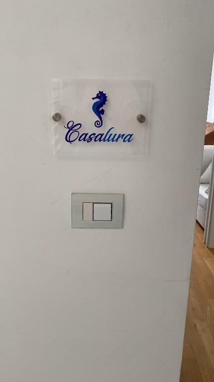 a refrigerator with a sign on the side of it at Casalura in Polignano a Mare