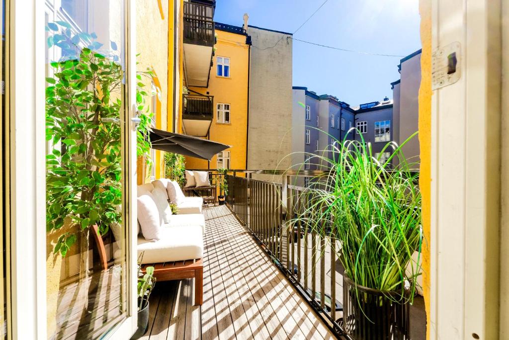 a balcony with a couch and plants on a building at Oslo Vest Hostel in Oslo