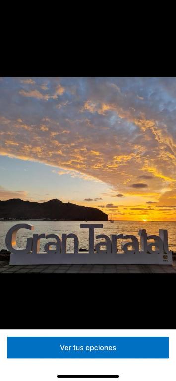 a picture of a boat in the water with a sunset at Edificio Juan Ávila cabrera in Gran Tarajal