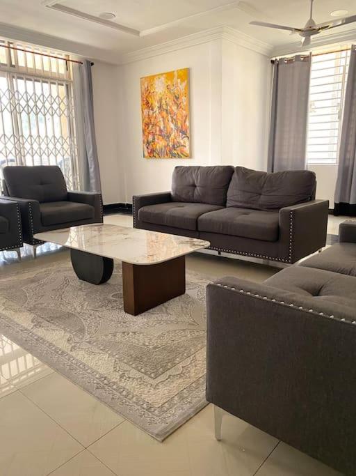 a living room with a couch and a coffee table at Spacious 2 Bedroom House East Legon Accra in Accra