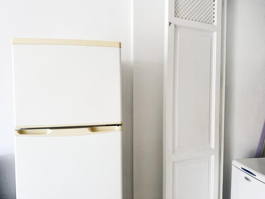 a refrigerator in a kitchen next to a door at !!! Relaxing View, The Heights Apartment With Terrace and Heated Pools, Los Cristianos in Los Cristianos