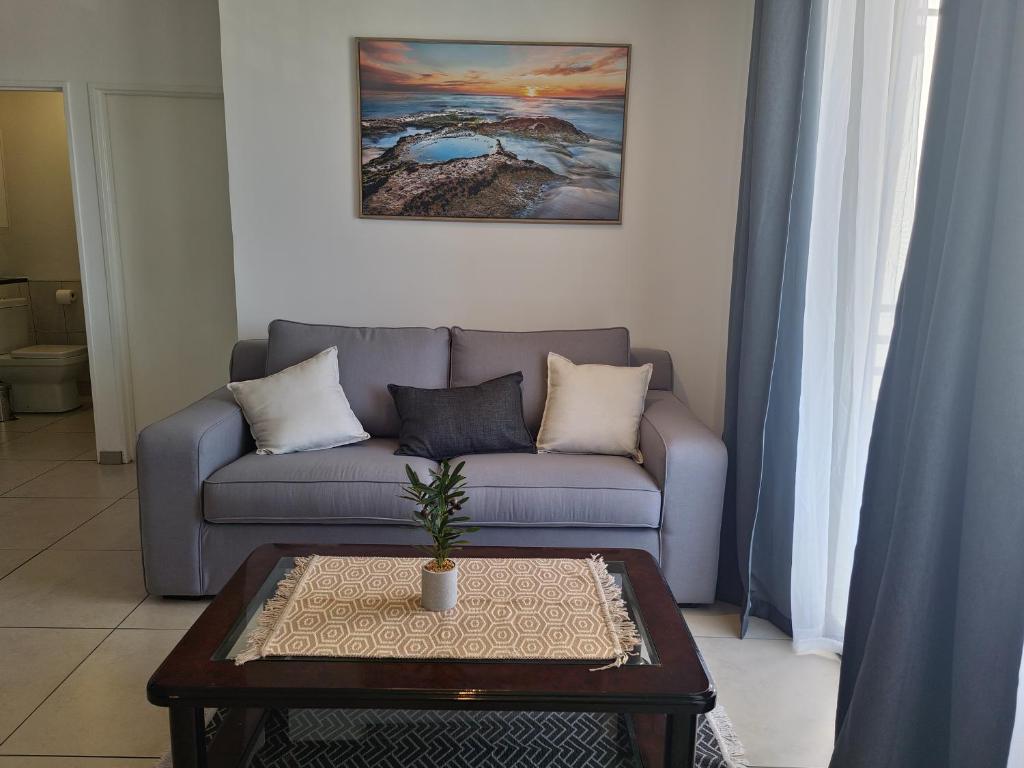a living room with a couch and a coffee table at City Junction Windhoek in Windhoek