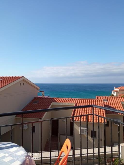 a balcony with a view of the ocean and buildings at Vista del Mare Rooms 2 in Agios Ioannis Kaspaka