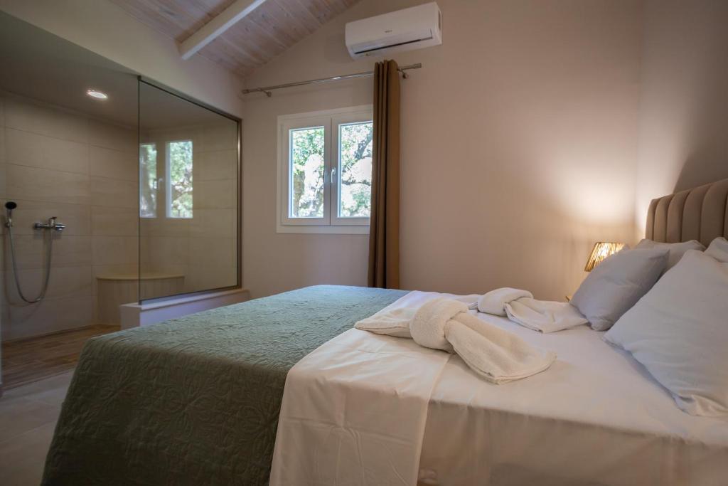 ein Schlafzimmer mit einem großen Bett und einer Dusche in der Unterkunft Irida Residence in Kerion