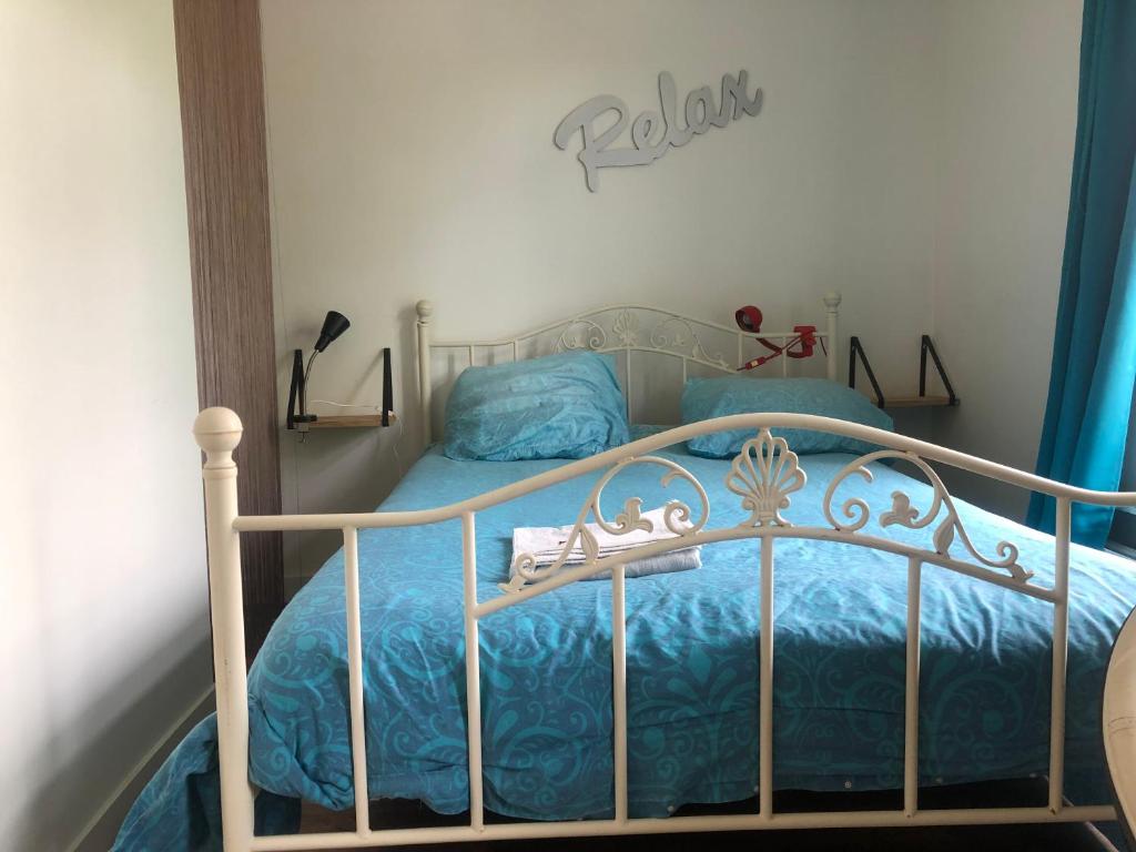 a bedroom with a bed with a blue comforter at Back-Stage in Nijmegen