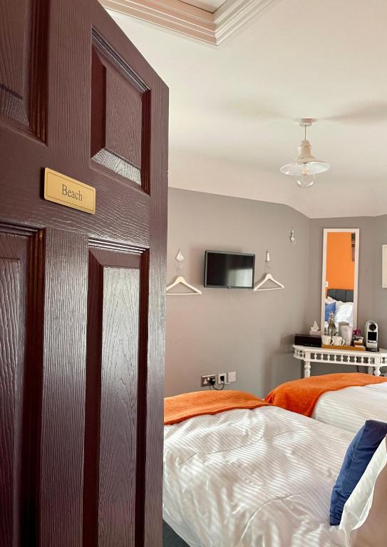 a bedroom with a bed and a sign on the door at Ebenezer's Place in Broadstairs