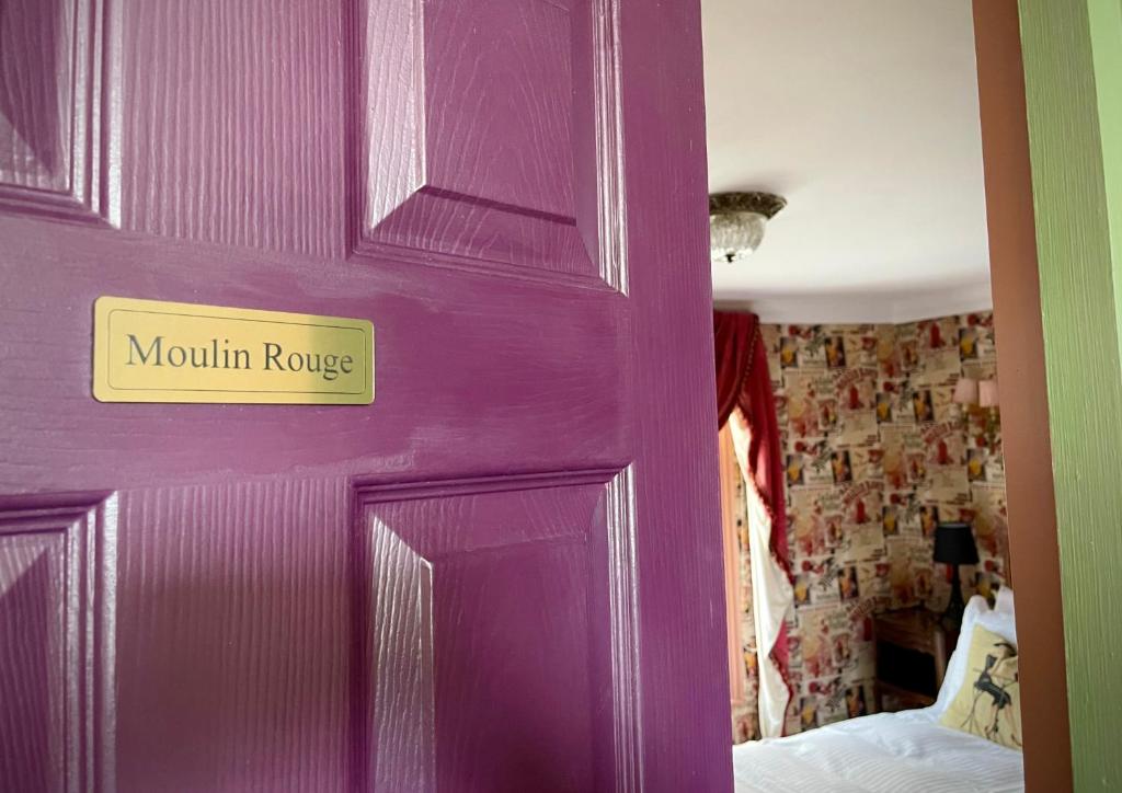 a purple door with a sign that reads mountain ridge at Ebenezer's Place in Broadstairs