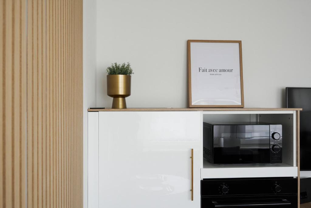 a tv on top of a white cabinet at Voyage in Kehl am Rhein