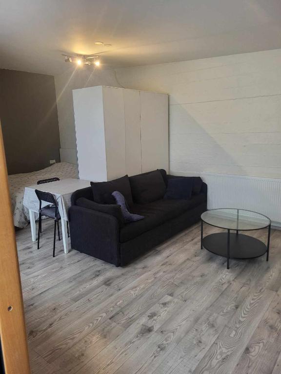 uma sala de estar com um sofá e uma mesa em Vallholt em Selfoss