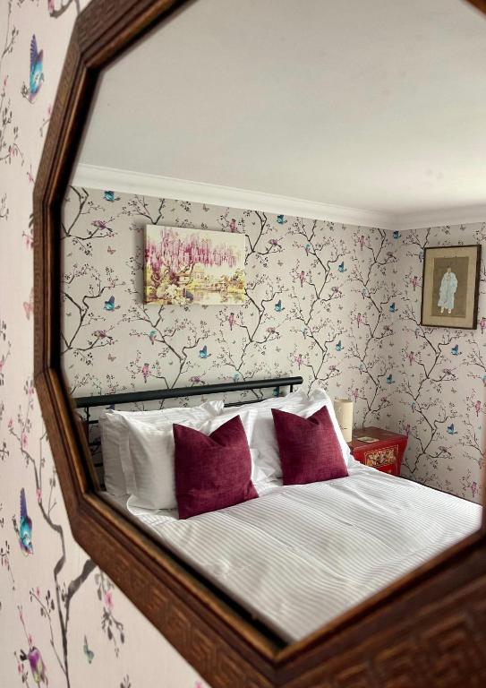 a mirror reflection of a bed in a bedroom at Ebenezer's Place in Broadstairs