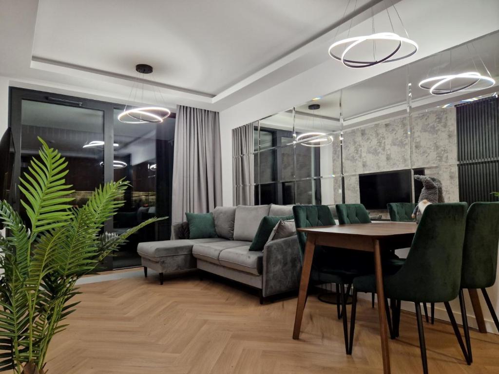 a living room with a couch and a table at Apartament w Bursztynowe Apartamenty Stegna in Stegna