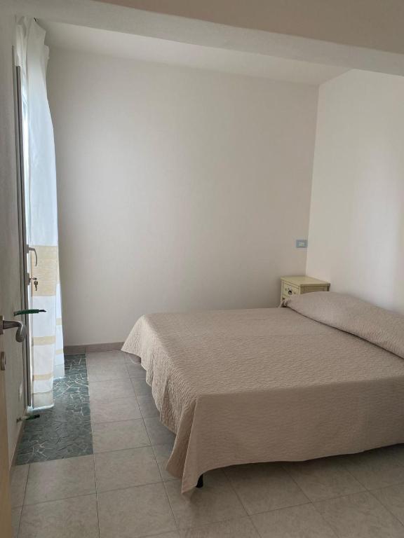 A bed or beds in a room at Borgo del Tennis - Sa Ventana 2