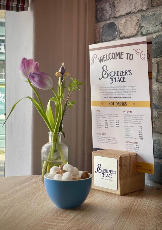 a table with a bowl of rocks and a box at Ebenezer's Place in Broadstairs