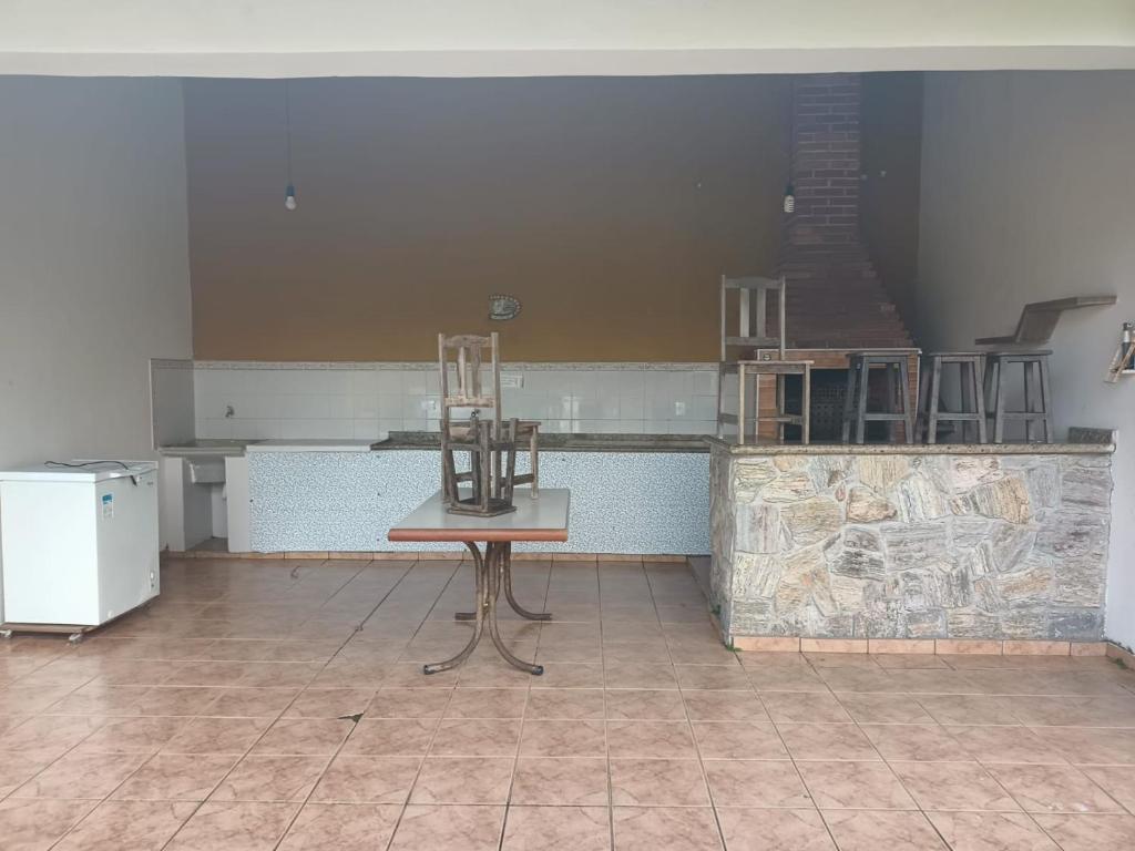 a chair sitting on a table in a room at Casa com Piscina na Morada da Praia in Bertioga