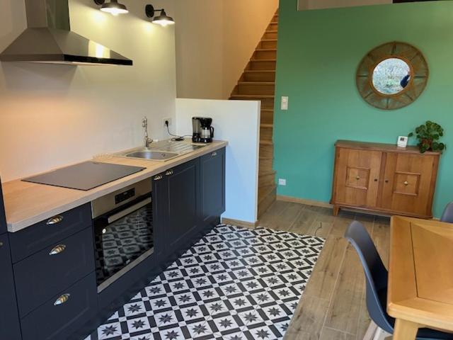 a kitchen with a sink and a counter top at Superbe logement "Loulaloue" ! in Ornans