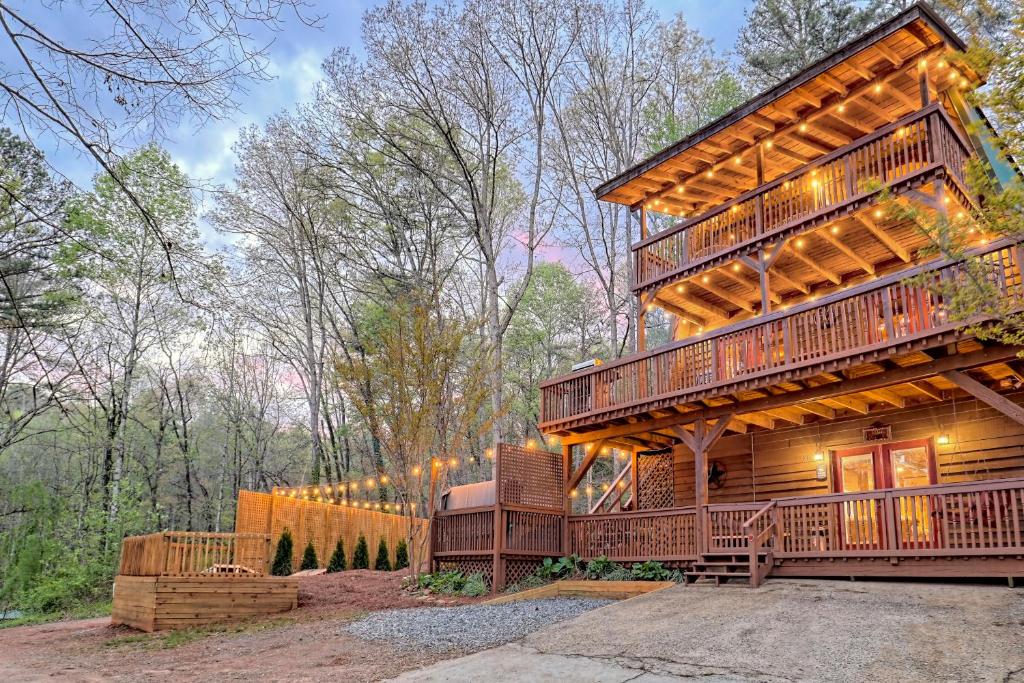 a cabin in the woods with a large deck at Near Downtown Helen - HotTub, Sauna, Game Room, Fire Pit in Helen