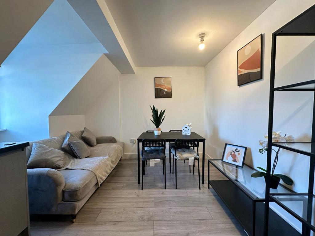 a living room with a couch and a table at Wembley Stadium Serviced Apartments, 12mins to Central London in London