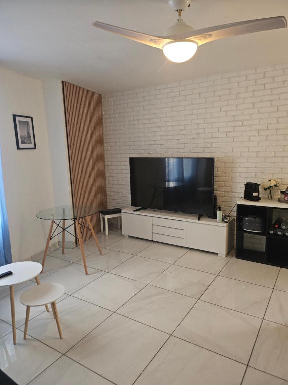 a living room with a large flat screen tv at KIFKIF in Saint-Germain-lès-Arpajon