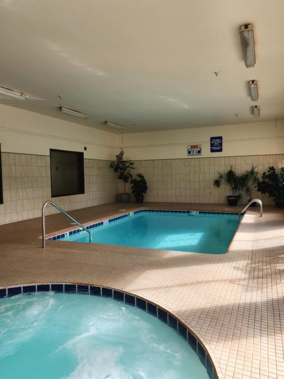 a large swimming pool in a building with a tv at Luxury Inn & Suites in Silverthorne