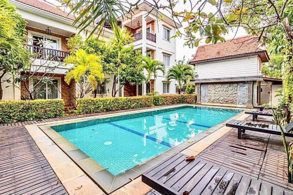 a swimming pool in the backyard of a house at Elegant Escape Residence in Siem Reap