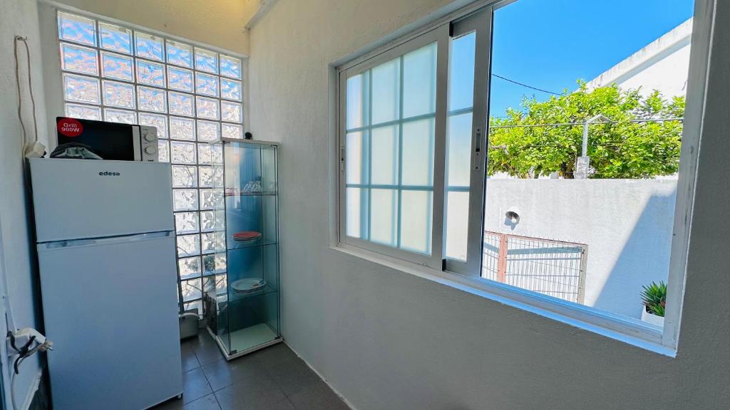 a white refrigerator in a room with a window at Dream home in Amora