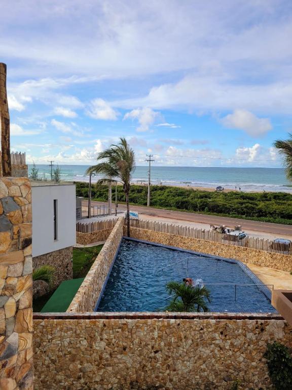 a swimming pool with the ocean in the background at casa in Flecheiras