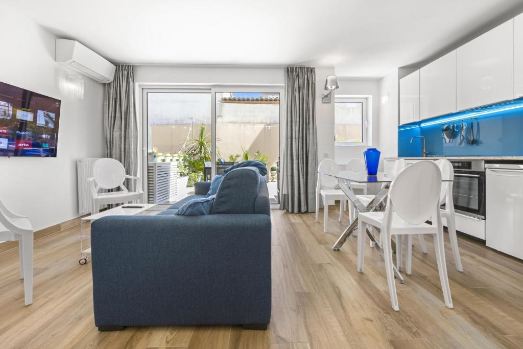 un salon avec un canapé bleu et une table dans l'établissement Cannes NG - Appartement à 10 mn du Palais des Festivals, à Cannes