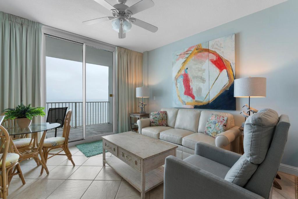 a living room with a couch and a table at Lighthouse By Liquid Life in Gulf Shores