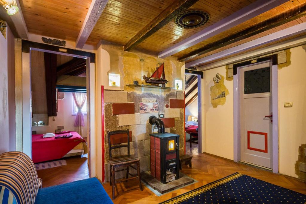 a living room with a wood stove in a room at Guest House Roman Horizon in Split