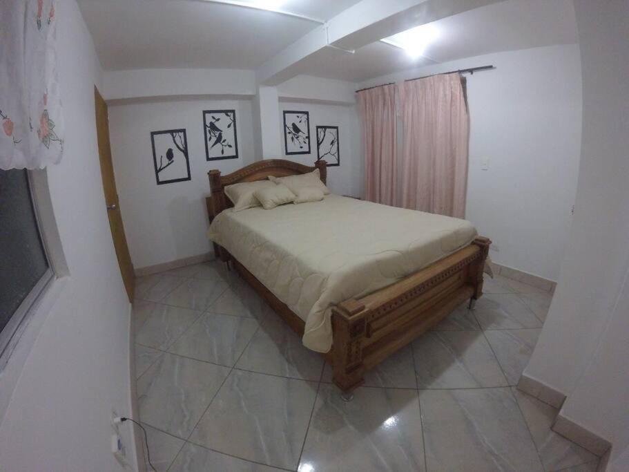 a bedroom with a large bed in a room at Right in the heart of Medellin in Medellín