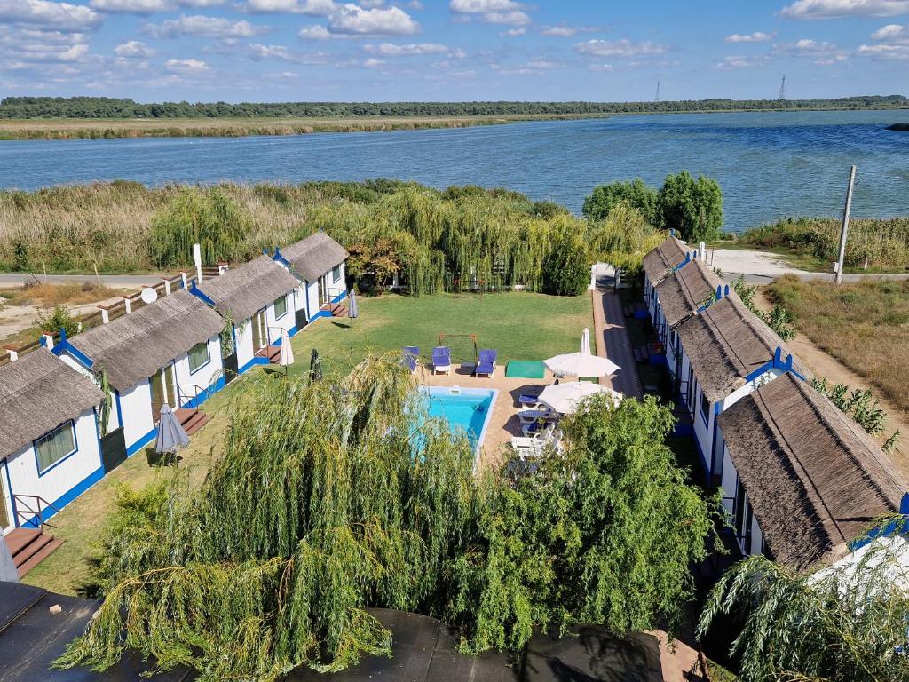 an aerial view of a row of cottages next to the water at Gulliver Delta Resort in Murighiol