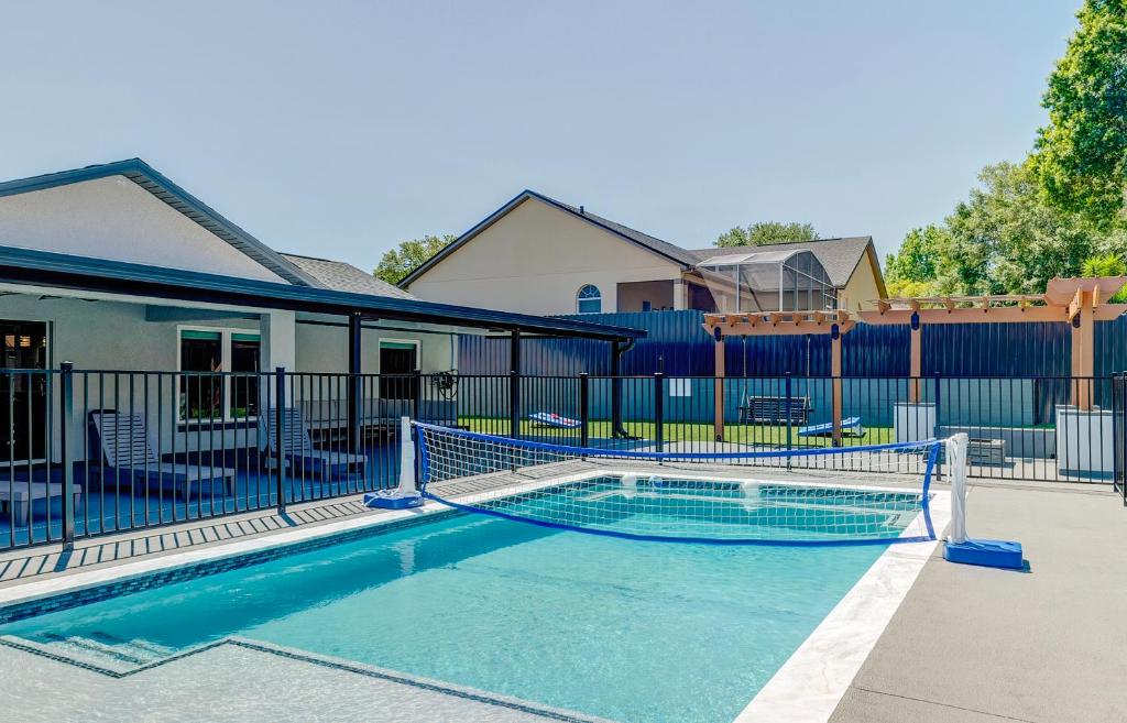 a swimming pool in front of a house at New Resort Style Oasis ~ LED Pool & Game Room in Minneola