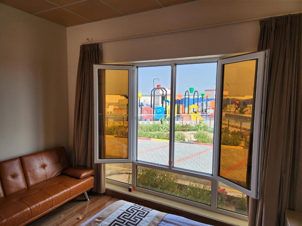 a living room with a window with a view of an amusement park at Lina Dreamland Resort in Billah