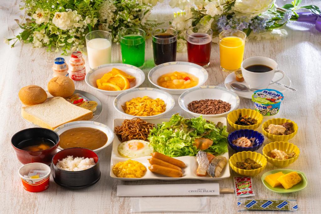 a table with many plates of food and drinks at Hotel Crystal Palace in Hitachinaka