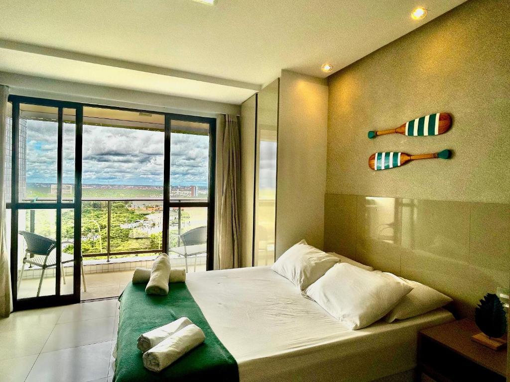 a bedroom with a bed with a view of the ocean at (903) Studio exclusivo e clima tropical in Vinhais