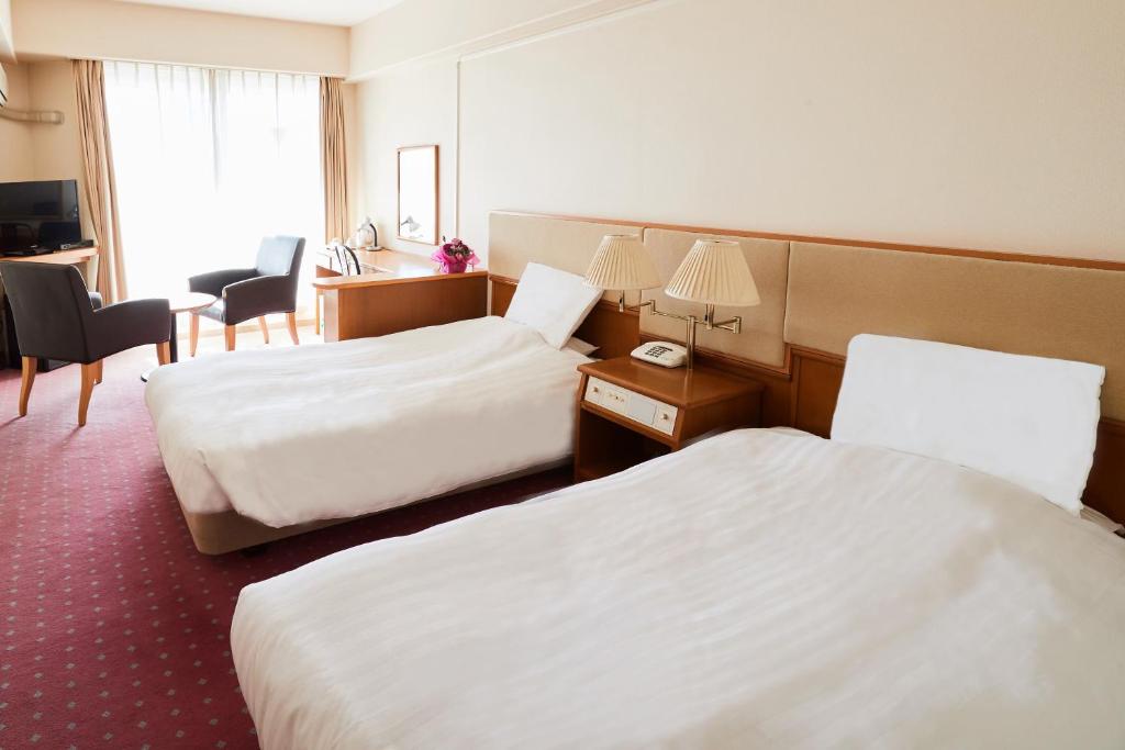 Postel nebo postele na pokoji v ubytování Hotel Crystal Palace