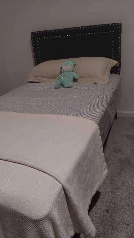 a teddy bear sitting on top of a bed at Travel Nurses Delight in De Land