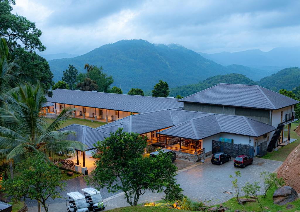 an overhead view of a building with mountains in the background at Simpson's Forest Hotel in Kandy