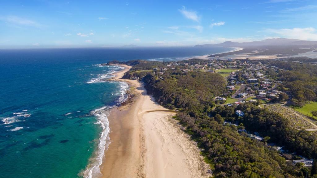 an aerial view of a beach and the ocean at BIG4 Tasman Holiday Parks - Nambucca Heads in Nambucca Heads