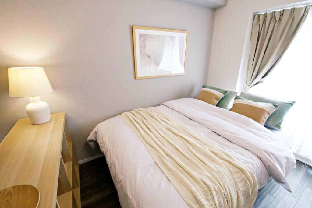 Postel nebo postele na pokoji v ubytování クレストYs千代田7B