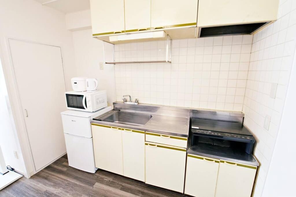 Kuchyň nebo kuchyňský kout v ubytování クレストYs千代田7B