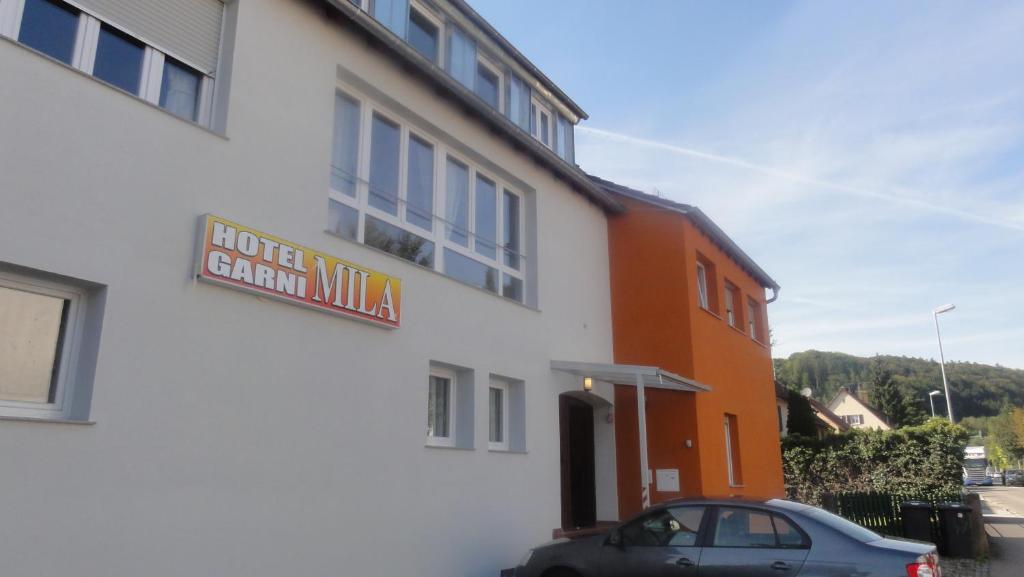 a car parked in front of a building at Hotel Mila in Reichenbach an der Fils